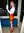 Curvy redhead bends over desk