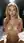Blonde lifts big tits in bed