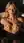 Blonde in bathtub squeezing her breasts