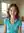 Brunette in turquoise shirt bedroom close-up
