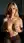 Young adult blonde holds breasts on couch