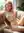 Pink hair nude on living room couch