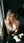 Early 20s blonde leans over table