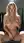 Curvy blonde spreads on stool