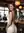 Wavy brunette smiles over shoulder at bar