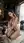 Naked brunette kneels in wine cellar