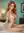 Nude redhead sitting cross-legged