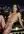 Nude on balcony railing at night