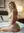 Blonde curves over shoulder glance