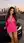 Curvy brunette in pink dress by car