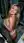 Topless blonde covers breasts in closet