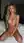 Kneeling nude on hotel bed
