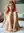 Legs spread nude on white sheets