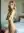 Nude blonde stands bedroom arms crossed