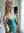 Quinn in sheer turquoise lace in a bright bedroom
