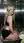 Curvy blonde in crop top kneels in elevator