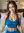 Tola smiles on bed in blue crop top