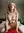 Reese in soft bedroom light, blonde and athletic in a relaxed full-body portrait