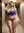 Curvy blonde in sequin bra hallway