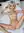 Faye reclines nude on white sheets