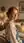 Young adult redhead over-the-shoulder bedroom glance