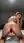 Blonde gripping anal plug on bed