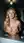 Blonde lifts breasts over washer