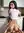 Mehak in a soft cashmere sweater, golden-hour light by the window