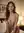 B-cup breasts on hotel bed