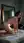 Nude brunette on bedroom floor