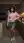 Asian in pink sweater kitchen pose