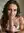 Calista locks eyes in warm bedroom light, playful wink and bitten lip
