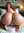 Ivy kneeling on bed, glancing back