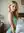 Slim blonde curves over shoulder