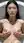 Slim Asian breasts cupped in bath