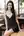 Brunette in short black dress at cafe