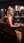 Blonde in backless burgundy dress at bar