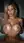 Blonde lifts wet breasts in tub
