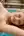 Topless blonde at pool edge