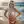 Blonde in white bikini arches back