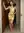 Backless gold dress doorway pose