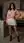 Asian in kitchen pink sweater pose
