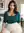 Curvy brunette cleavage bedroom pose