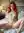 Redhead spreads on white hotel bed