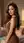 Brunette waves over shoulder glance