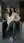 Wavy brunette leans in kitchen