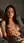 Brunette topless on bed at dawn