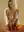 warm string lights glow on sheer white halter with metal ring neckline