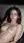 Brunette reclines topless on terrace