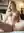Platinum blonde spreads on white sheets